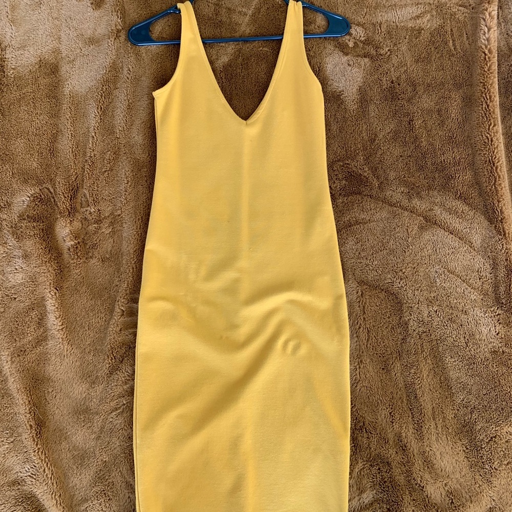 A yellow, low v, comfortable, soft fabric dress.